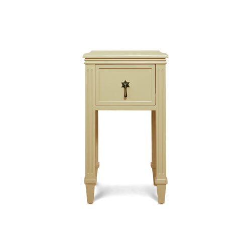 A singular, mini bedside table with a star-shaped pull handle.