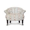 A blue and white armchair with a floral design and castor wheels.