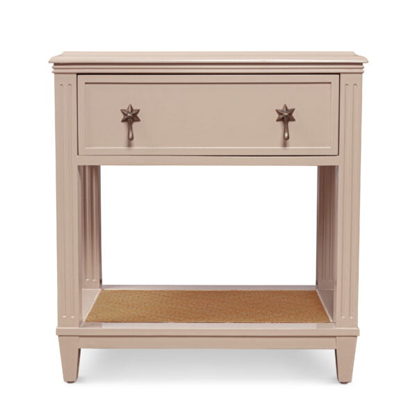 A beige wooden bedside table with star-shaped handles.