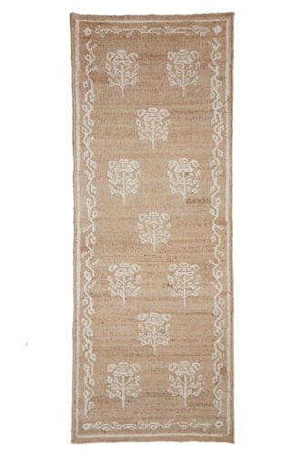 A brown floor runner-rug with a white poppy stitched pattern.