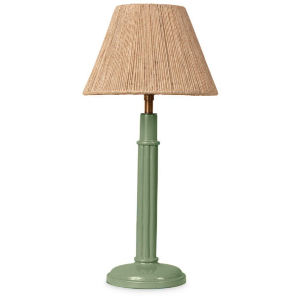 A fern-green coloured lamp with a cotton lampshade and the light off.